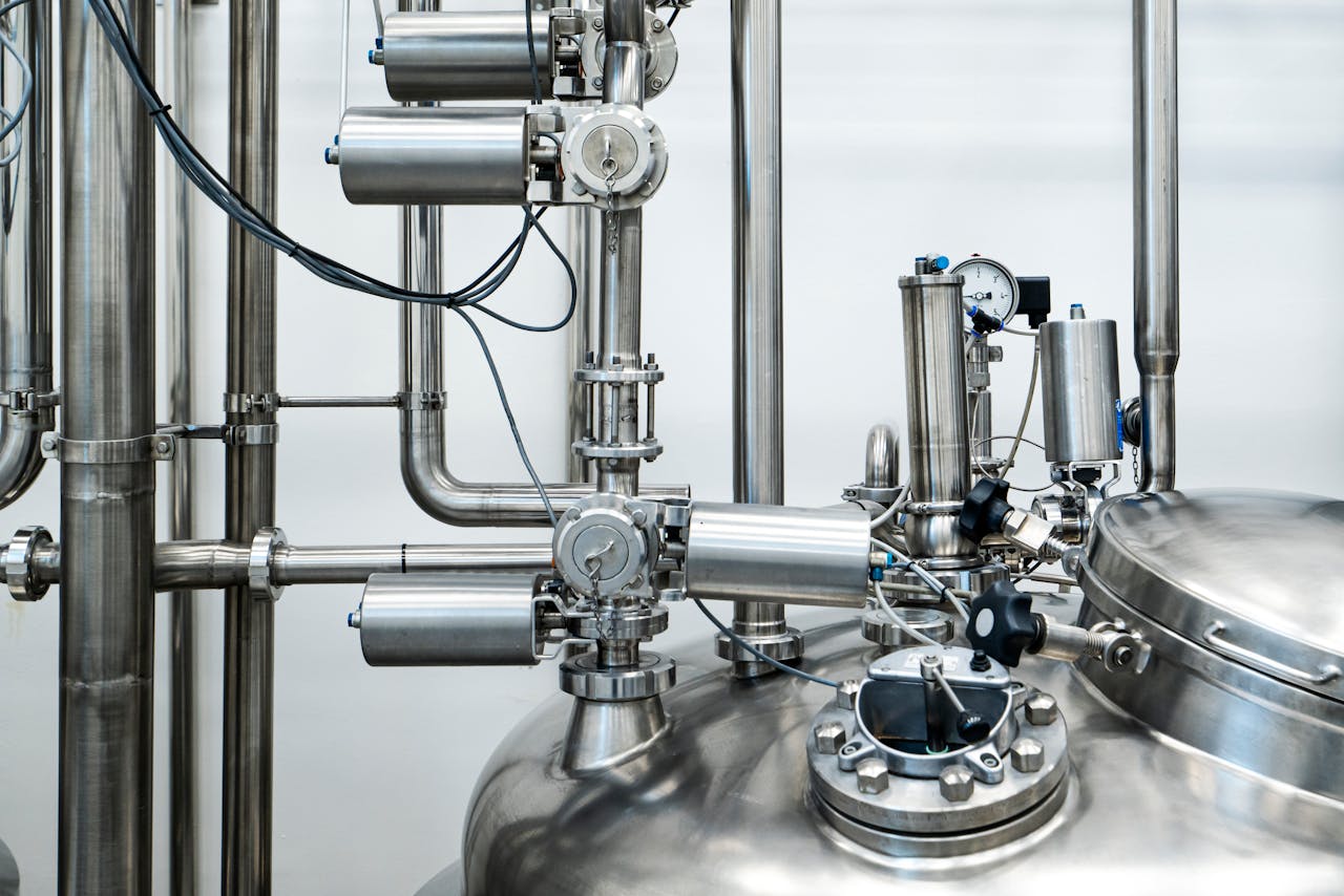 The Art of Drawing Readers In: Your attractive post title goes here Close-up of stainless steel machinery and pipes in an industrial setting, showcasing modern engineering.